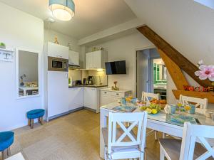 a kitchen and dining room with a table and chairs at Apartment Le Château de Kergonano-10 by Interhome in Baden