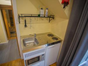 a small kitchen with a sink and a stove at Chalet Cobbs by Interhome in Drumnadrochit