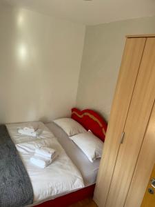 a small room with a bed and a closet at Bap-Belt apartment in Bačka Palanka