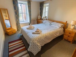 a bedroom with a bed with two towels on it at Holiday Home Lodge Road-2 by Interhome in Inverness