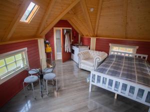 a bedroom with a bed and a kitchen in a room at Chalet Campbell by Interhome in Drumnadrochit