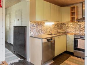 a kitchen with a sink and a stove at Holiday Home Purontupa by Interhome in Sotkamo +31 photos