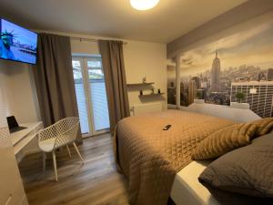 a bedroom with a large bed and a large window at New York Appartement in Bad Salzuflen