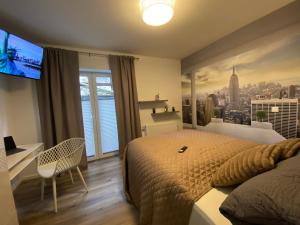 a bedroom with a large bed and a flat screen tv at New York Appartement in Bad Salzuflen