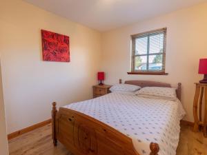a bedroom with a bed and a red picture on the wall at Apartment Miller Apartment by Interhome in Inverness