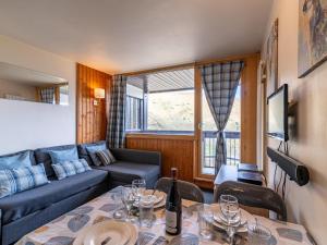 a living room with a couch and a table at Studio Home Club - Lavachet-12 by Interhome in Tignes