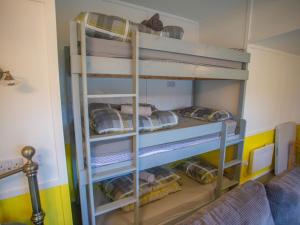 a bunk bed in a room with bunk beds at Chalet Dougie's by Interhome in Drumnadrochit