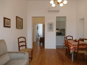 a living room with a couch and a table and chairs at Apartment Fiori e Canzoni by Interhome in Sanremo
