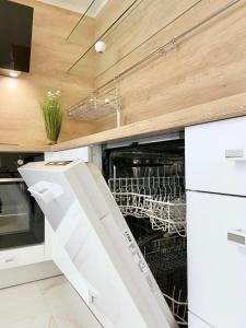 een keuken met een lege vaatwasser bij Sea View Apartment with Free Parking in Pomorie