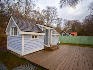 a tiny house on a wooden deck at Chalet Affric 3 by Interhome in Drumnadrochit