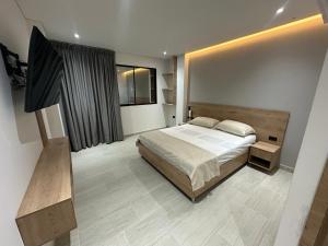 a bedroom with a large bed and a window at Hotel La Casona San Sebastian in Doradal