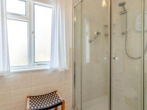 a shower with a glass door in a bathroom at 3 bed in Kirriemuir 82244 in Kirriemuir