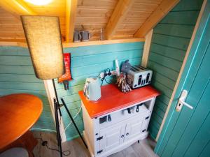 a small kitchen with a stove in a tiny house at Chalet Glen by Interhome in Drumnadrochit