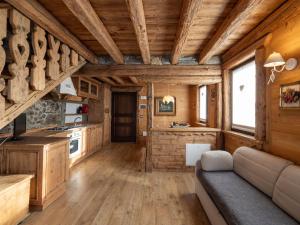 a kitchen and living room in a log cabin at Apartment by Interhome 