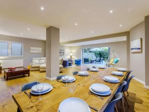 a dining room with a long table and chairs at 4 bed in Worthing 83354 in Ferring