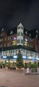 a large building with a christmas tree in front of it at FeWo Küste in Nordenham