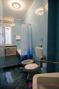 a blue bathroom with two toilets and a shower at Borgo Maria Luigia, prot. PG 0209465 in Parma