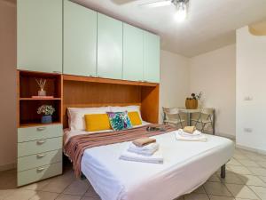 a bedroom with two beds and a cabinet at Apartment 0-5-N - Marineledda by Interhome in Golfo Aranci