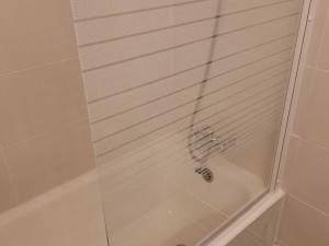 a shower stall with a glass shower door with a drain at Studio Valloire, 1 pièce, 4 personnes - FR-1-263-55 in Valloire