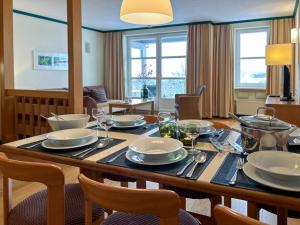 a dining room with a table with dishes on it at UplandParcs Bergresidence in Winterberg