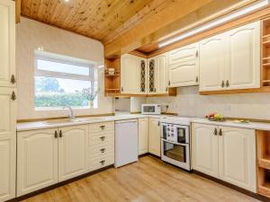 a kitchen with white cabinets and a window at 3 Bed in Sedgefield 82600 in Sedgefield