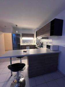 a kitchen with a counter and a stove top oven at l'arc logement in Strasbourg