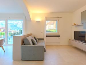 a living room with a couch and a television at Holiday Home Uliveto by Interhome in Colico