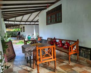 a living room with a table and chairs and a patio at Dickwella Green Villa in Dickwella