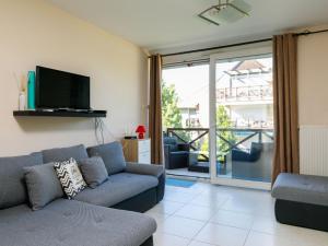 a living room with a couch and a tv at Studio Karen by Interhome in Balatonőszöd