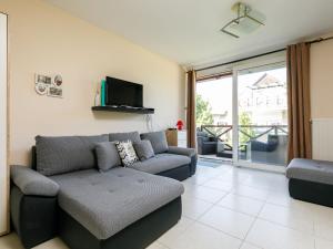 a living room with a couch and a tv at Studio Karen by Interhome in Balatonőszöd