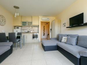 a living room with a couch and a kitchen at Studio Karen by Interhome in Balatonőszöd +31 photos