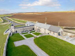 an aerial view of a church with a grass field at 8 bed in Southerndown 86493 in Southerndown