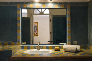a bathroom with a sink and a mirror at Jack's Apartments & Suites in Essaouira +179 photos