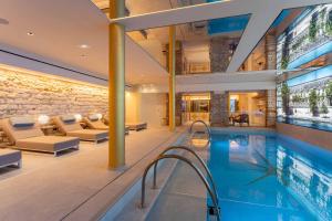 a pool in a house with a living room at Hotel Astra Opera - Astotel in Paris