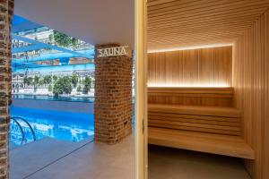 an empty sauna next to a swimming pool at Hotel Astra Opera - Astotel in Paris