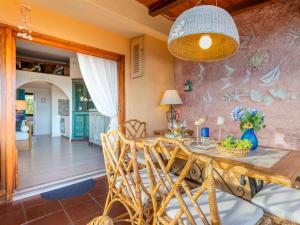 a dining room with a table and chairs at Apartment E-1-4 - Marineledda by Interhome in Golfo Aranci