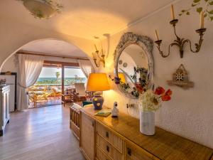 a living room with a table with a vase of flowers at Apartment E-1-4 - Marineledda by Interhome in Golfo Aranci