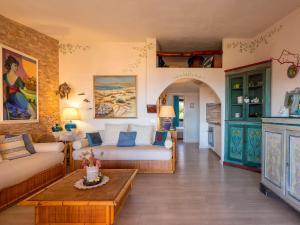 a living room with a couch and a table at Apartment E-1-4 - Marineledda by Interhome in Golfo Aranci +35 photos