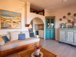 a living room with a couch and a kitchen at Apartment E-1-4 - Marineledda by Interhome in Golfo Aranci