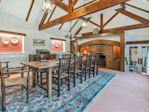 a dining room with a table and a fireplace at 5 Bed in Thorpe 85565 in Thorpe