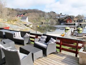 a deck with chairs and a view of a river at Holiday Home Kalavåg by Interhome in Kalavåg