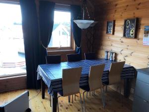 a dining room with a blue table and chairs at Holiday Home Kalavåg by Interhome in Kalavåg +15 photos