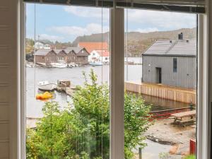 a window with a view of a body of water at Holiday Home Kalavåg by Interhome in Kalavåg