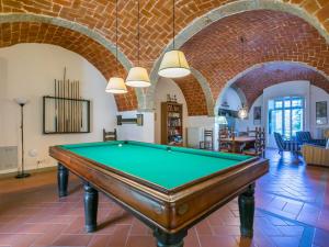 a pool table in a room with brick walls at Holiday Home Al Volo del Nibbio by Interhome in Marradi