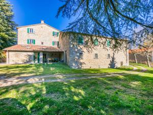 an external view of a stone house with a yard at Holiday Home Al Volo del Nibbio by Interhome in Marradi