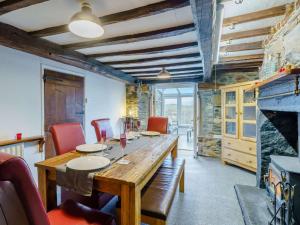 a dining room with a wooden table and red chairs at 4 Bed in Keswick 86250 in Threlkeld +15 photos