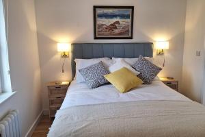 a bed with pillows on it in a bedroom at Rural Cornish Cottage in Truro