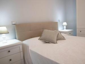 a bedroom with a large bed with two night stands at Apartment Bilo Satta by Interhome in Trinità d'Agultu e Vignola