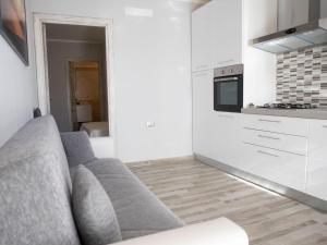 a living room with a couch and a kitchen at Apartment Bilo Satta by Interhome in Trinità d'Agultu e Vignola