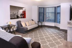 ein Wohnzimmer mit einem Sofa und einer roten Telefonzelle in der Unterkunft Exclusive 8beds 2bath Luxury Contractors Delight! in Southampton